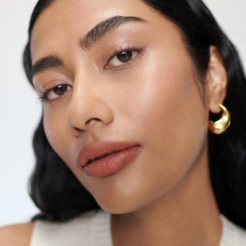 Shikin wears Signature Lipstick in shade Antibes