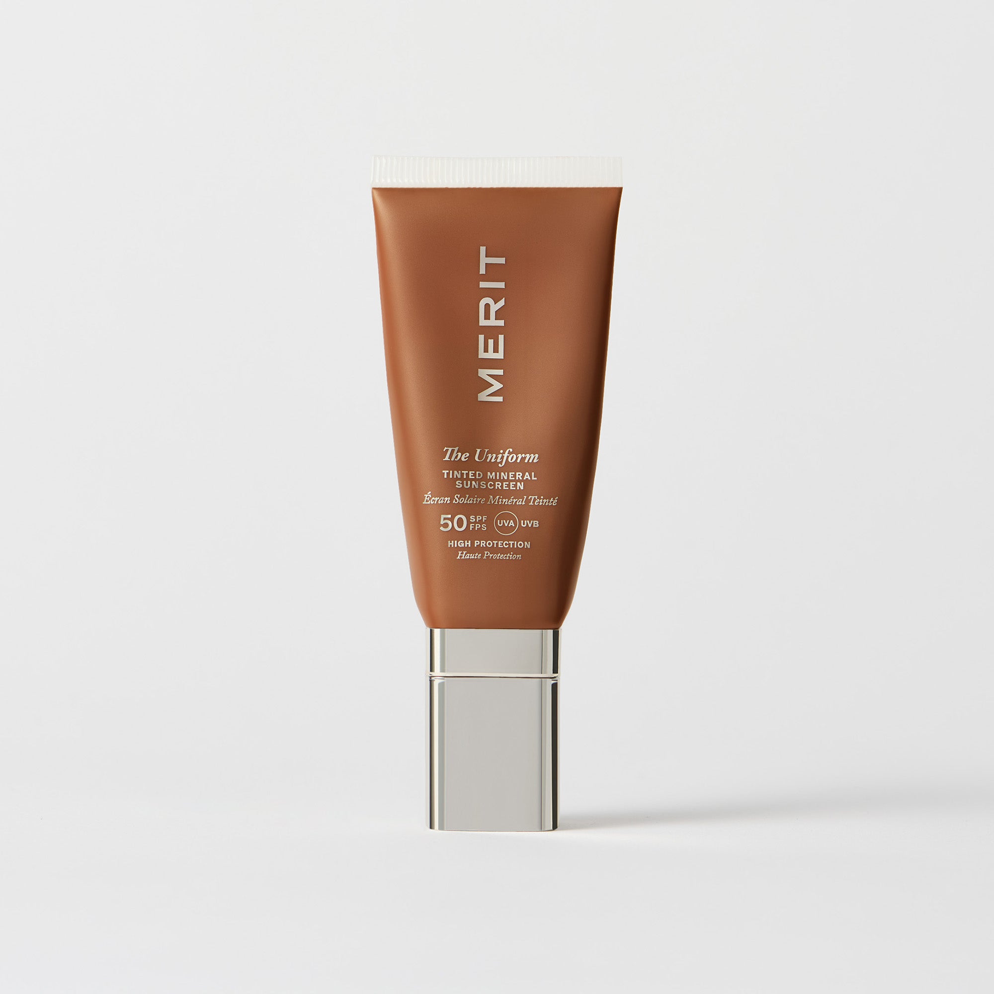 Master || A tube of MERIT brand mineral sunscreen with a sheer tint finish, providing broad spectrum 50 UVA/UVB protection, displayed against a white background. In shade 08