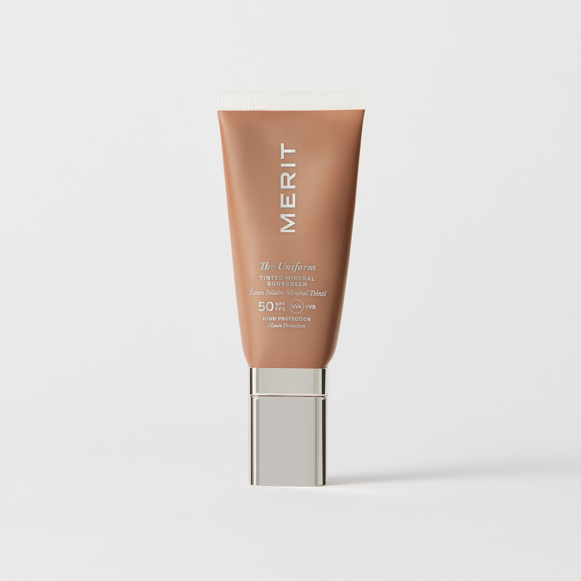 Master || A tube of MERIT brand mineral sunscreen with a sheer tint finish, providing broad spectrum 50 UVA/UVB protection, displayed against a white background.
Shade 10