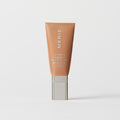 Master || A tube of MERIT brand mineral sunscreen with a sheer tint finish, providing broad spectrum 50 UVA/UVB protection, displayed against a white background. Shade 12