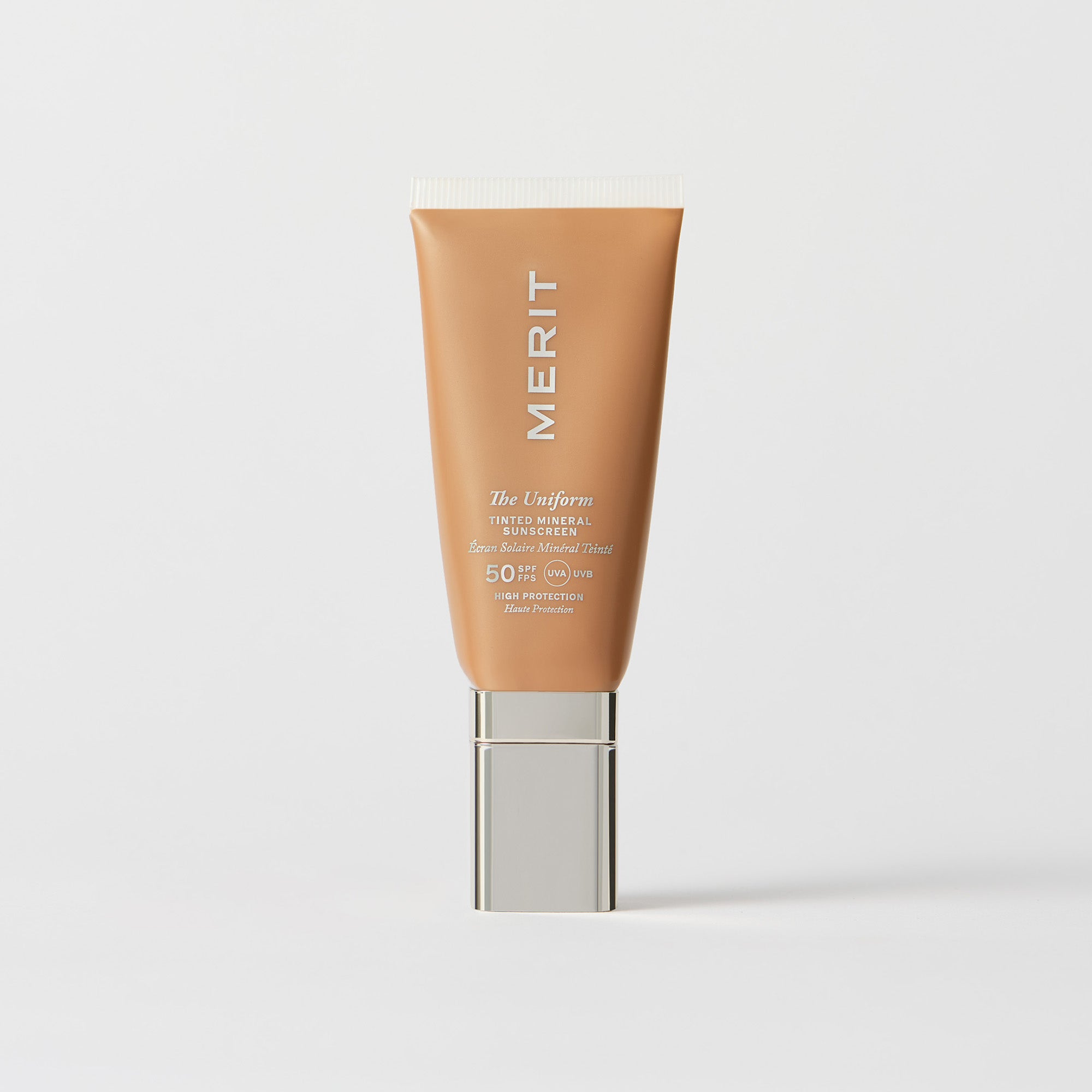 Master || A tube of MERIT brand mineral sunscreen with a sheer tint finish, providing broad spectrum 50 UVA/UVB protection, displayed against a white background. Shade 14 