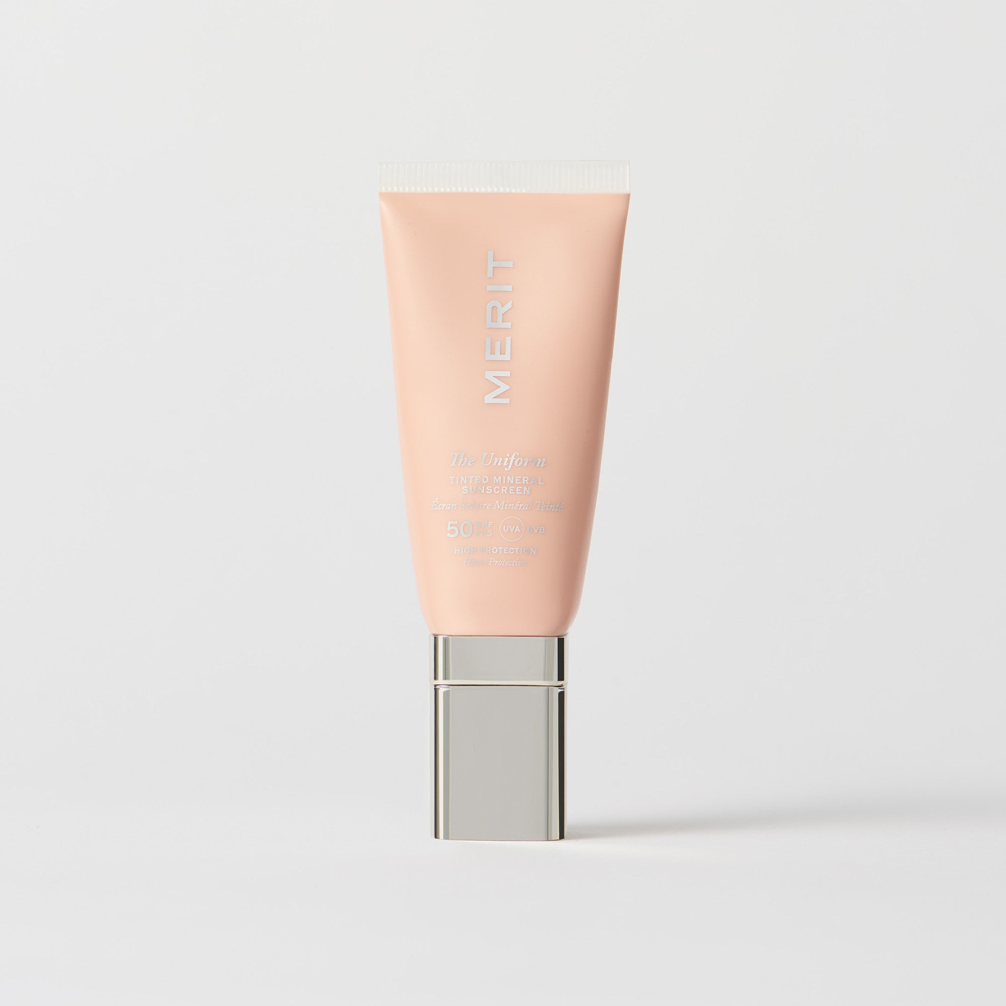 Master || A tube of MERIT brand mineral sunscreen with a sheer tint finish, providing broad spectrum 50 UVA/UVB protection, displayed against a white background. Shade 30