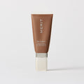Master || A tube of MERIT brand mineral sunscreen with a sheer tint finish, providing broad spectrum 45 UVA/UVB protection, displayed against a white background. Shade 06