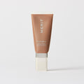 Master || A tube of MERIT brand mineral sunscreen with a sheer tint finish, providing broad spectrum 45 UVA/UVB protection, displayed against a white background. Shade 10