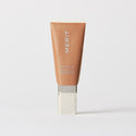 Master || A tube of MERIT brand mineral sunscreen with a sheer tint finish, providing broad spectrum 45 UVA/UVB protection, displayed against a white background. Shade 12