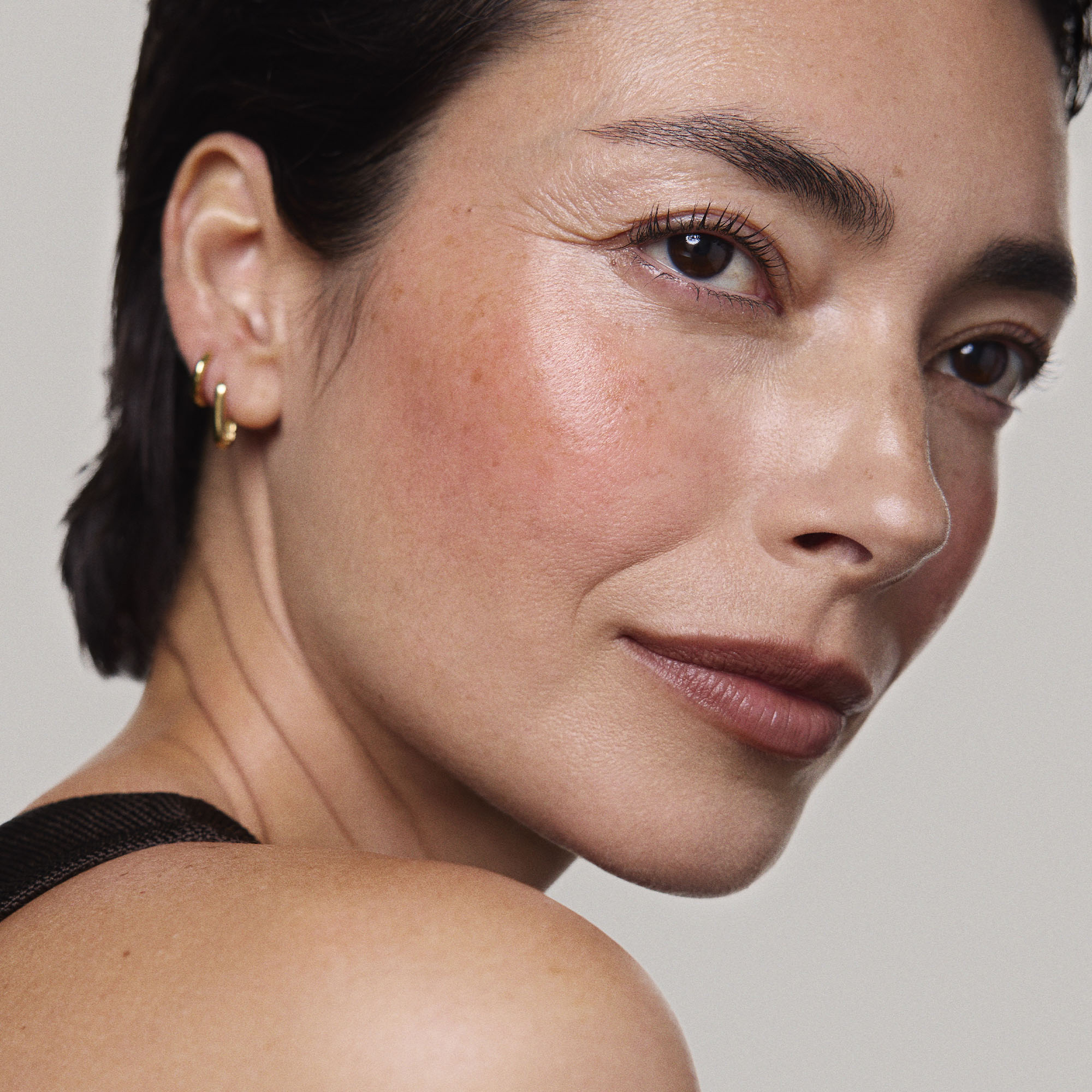 Persimmon | face::light |  Model is wearing Flush Balm in shade Persimmon.