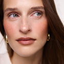 Persimmon | face::fair  |  Model is wearing Flush Balm in shade Persimmon.