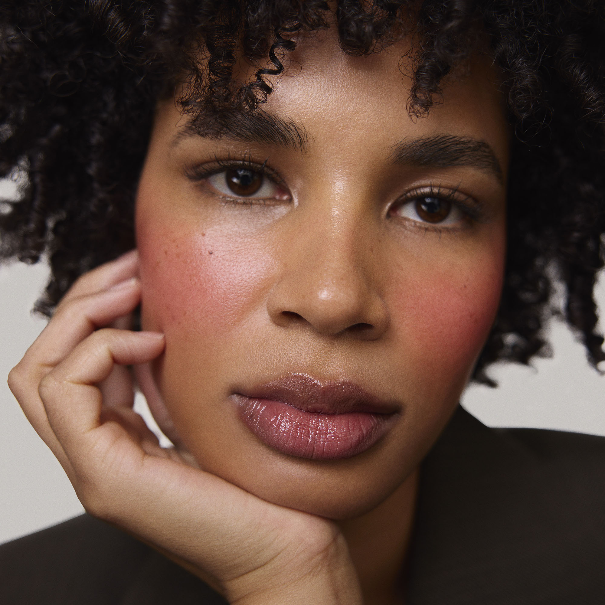 Rouge | face::deep | Model is wearing Flush Balm in shade Rouge.
