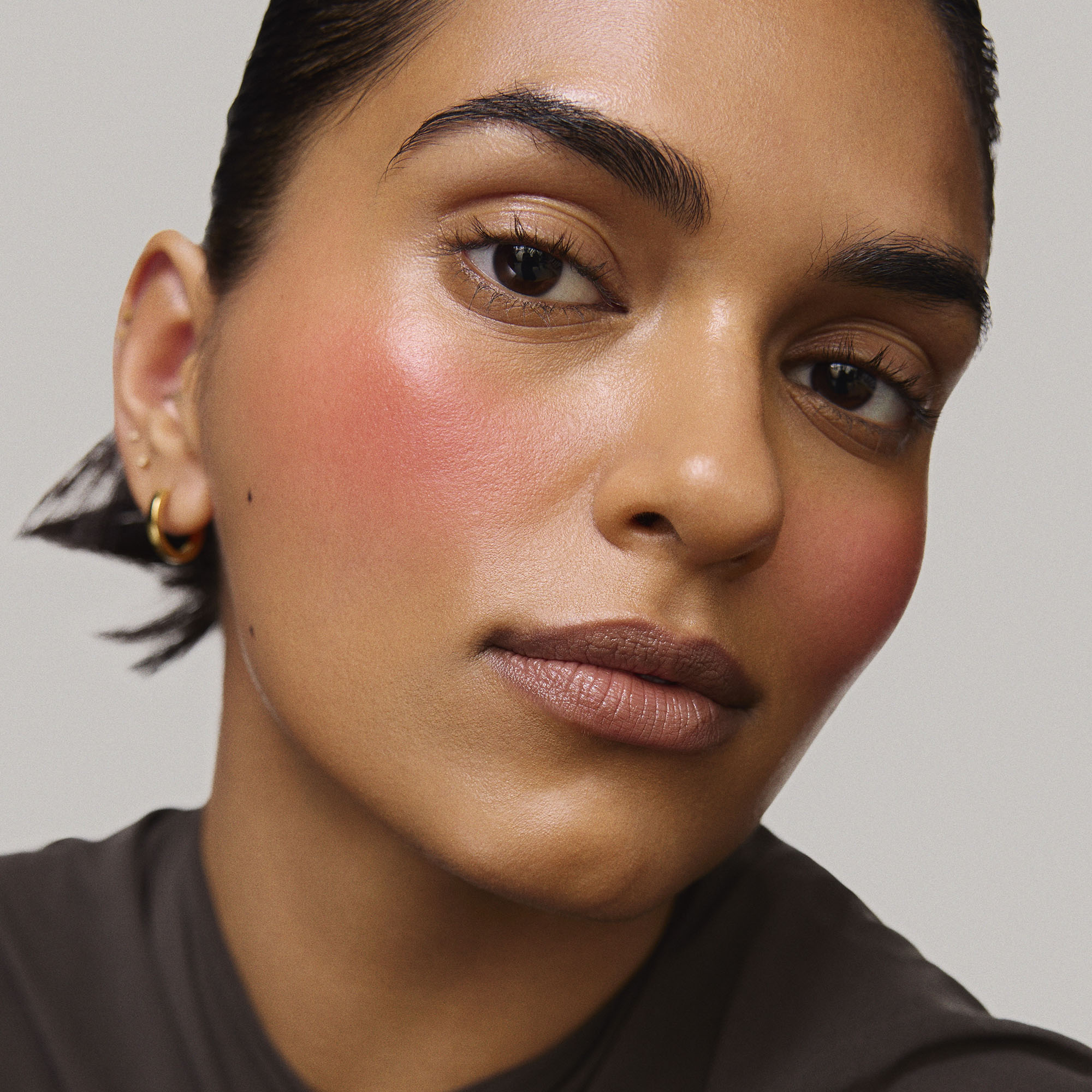 Rouge | face::medium | Model is wearing Flush Balm in shade Rouge.