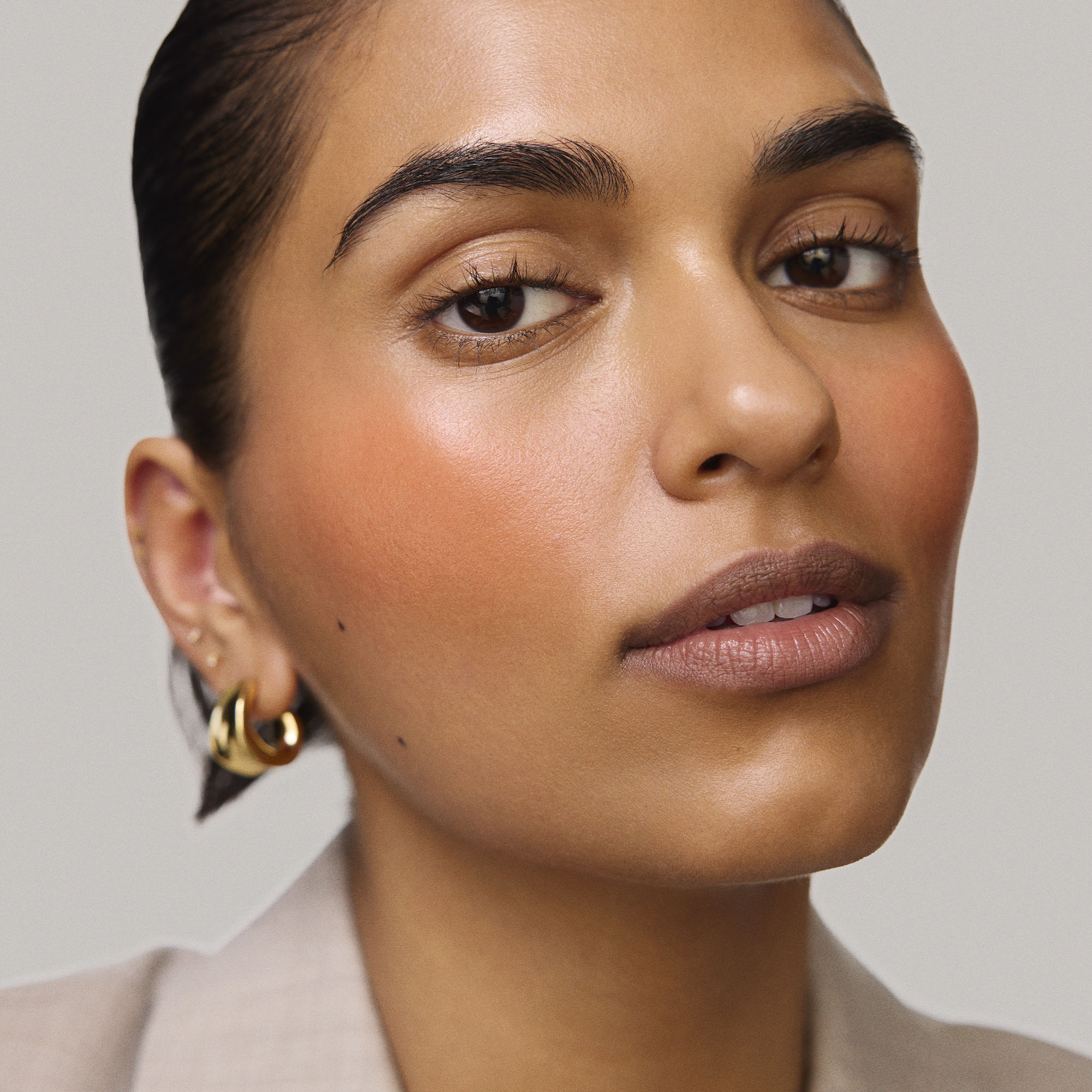 Master || Model is wearing Flush Balm in shade Terracotta.