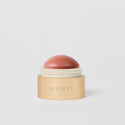 Master ||  A cream blush balm by Merit Beauty in color Beverly Hills and gold body.